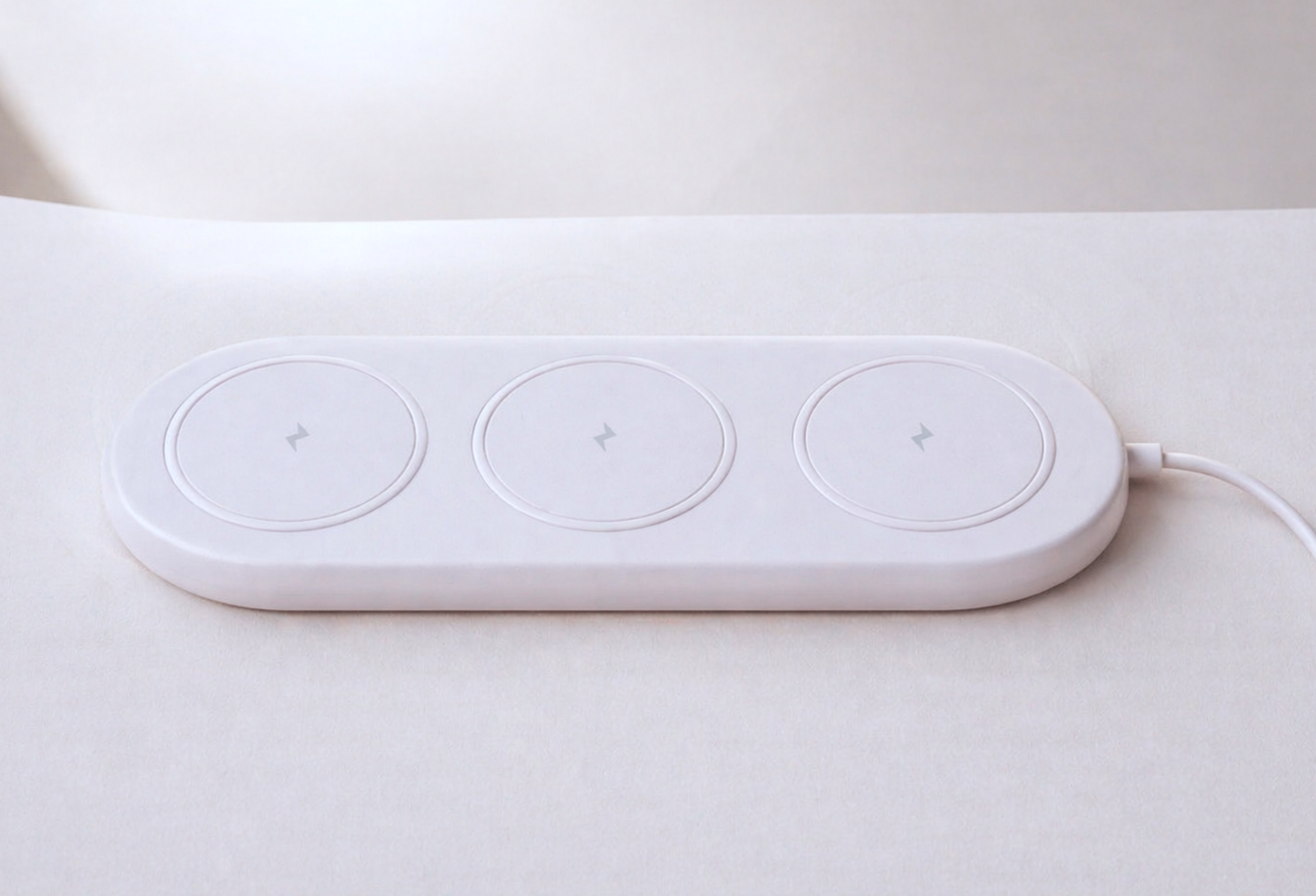 Lumi wireless charger render with a soft charging base for sealed adult wearables